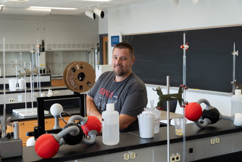 Photo of Prof. Kuhar with 3-D printed large-scale molecular models