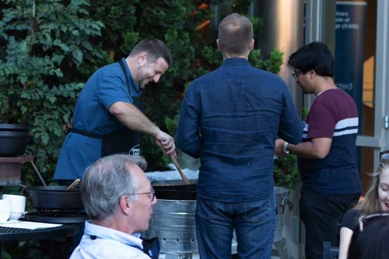 Photo of Professor Kuhar cooking for the crowd at the Chemistry  Department Homecoming Reception in 2021